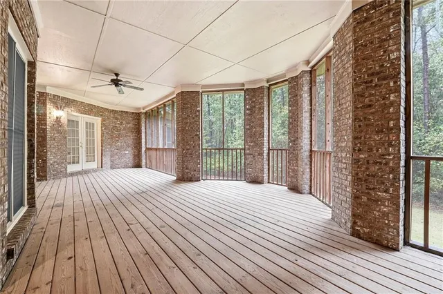 a bedroom with a bed and a large window with outer view