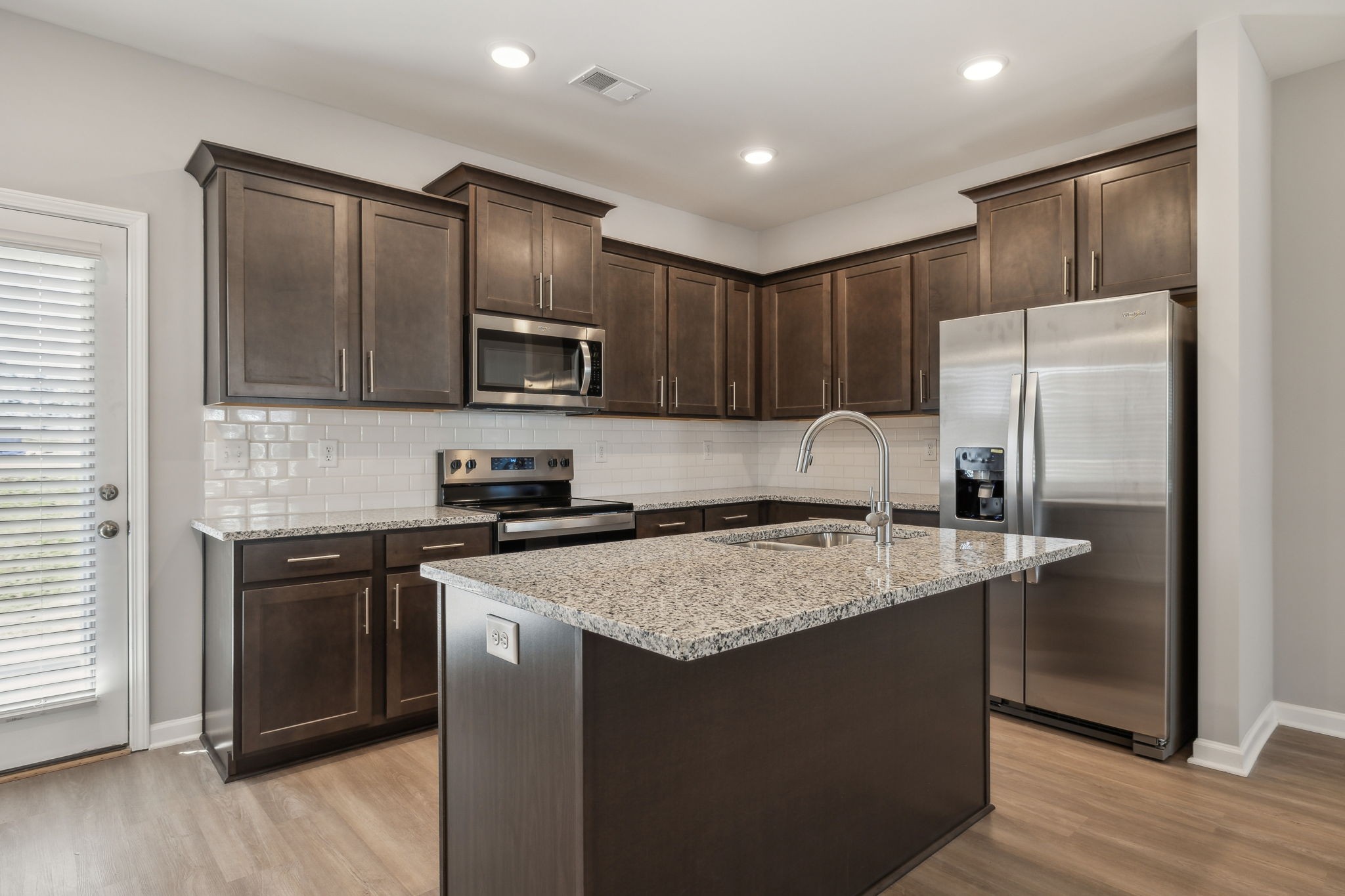Undisclosed Address Lebanon, TN 37087 - Photo 5 of 13 a kitchen with stainless steel appliances granite countertop a stove a sink dishwasher a refrigerator and a microwave oven with wooden floor