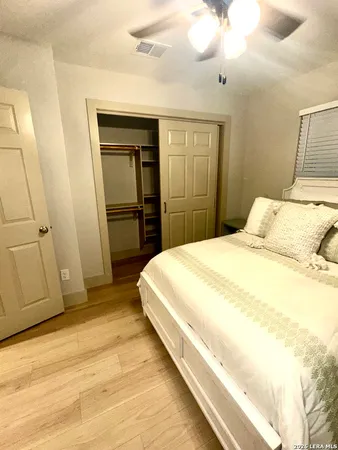 a bedroom with a bed and a mirror