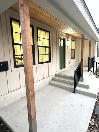 a view of an entryway with a floor to ceiling window and a living room