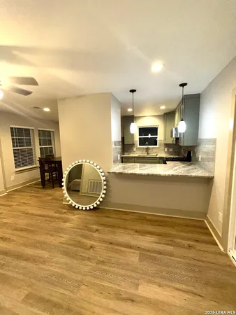 a view of kitchen with stainless steel appliances granite countertop sink stove and cabinets