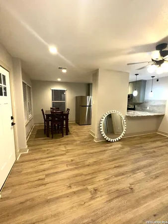 a view of a kitchen with kitchen island stainless steel appliances refrigerator stove microwave and cabinets
