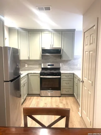 a kitchen with a refrigerator stove and sink