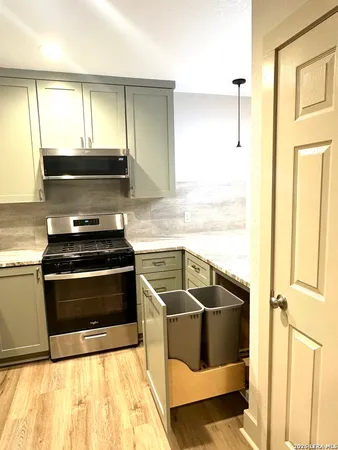 a kitchen with granite countertop a stove and a sink