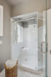 a bathroom with a shower and a sink