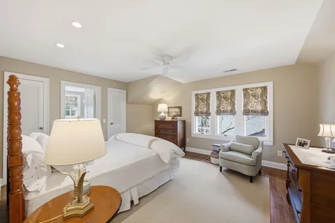 a spacious bedroom with a bed and large windows