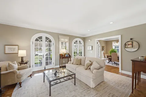 a living room with furniture a couch and wooden floor