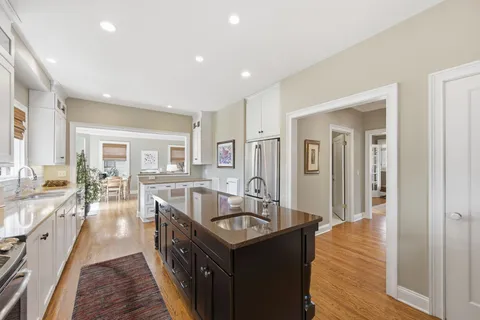 a kitchen with counter top space sink stove and refrigerator