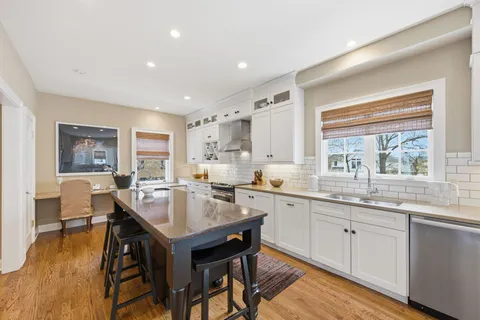 a kitchen with center island and windows