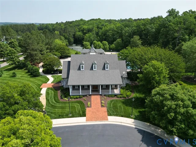 an aerial view of a house with a yard table and chairs