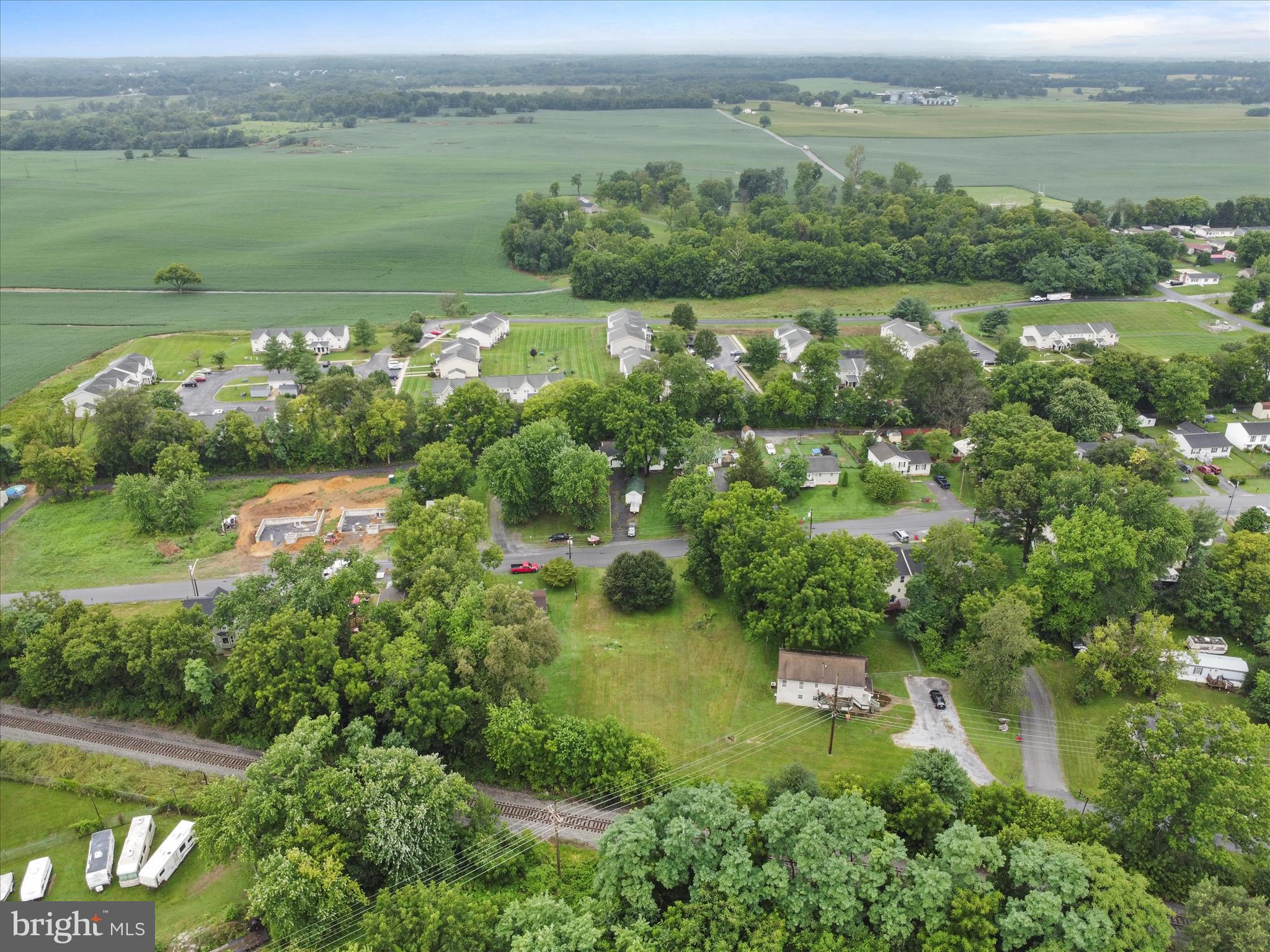 406 Burns Street Ranson, WV 25438 - Photo 12 of 32 an aerial view of green landscape with trees houses and lake view