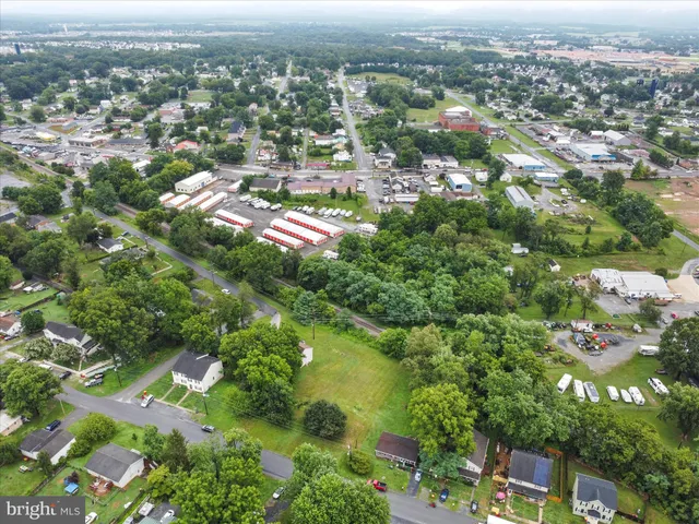 an aerial view of residential houses with city view
