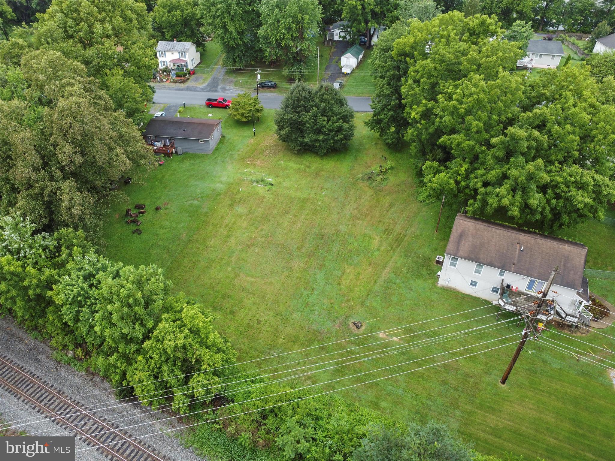 406 Burns Street Ranson, WV 25438 - Photo 4 of 32 a backyard of a house with table and chairs a barbeque