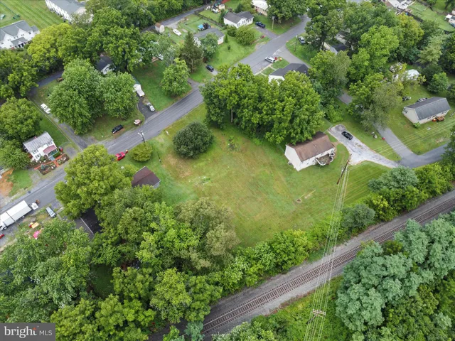 a backyard of a house with a yard and outdoor seating