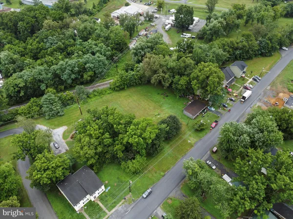 an aerial view of a house with a yard basket ball court and outdoor seating