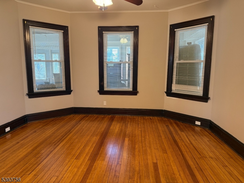 32 Montclair Avenue, Unit 1 Montclair, NJ 07042 - Photo 3 of 14 a view of an empty room with wooden floor and a window