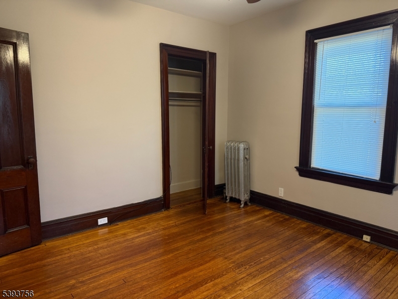 32 Montclair Avenue, Unit 1 Montclair, NJ 07042 - Photo 8 of 14 a view of an empty room with wooden floor and a window