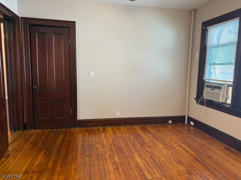 32 Montclair Avenue, Unit 1 Montclair, NJ 07042 - Photo 9 of 14 an empty room with wooden floor and windows