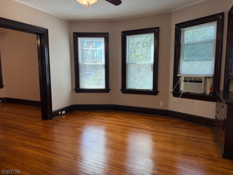 32 Montclair Avenue, Unit 1 Montclair, NJ 07042 - Photo 10 of 14 a view of an empty room with wooden floor and a window