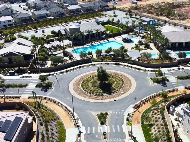 an aerial view of a swimming pool with outdoor seating