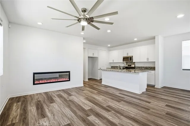 a view of kitchen with sink microwave and refrigerator