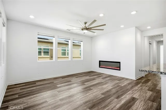 a view of a livingroom with a ceiling fan and window