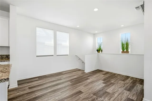 a view of a room with wooden floor and window