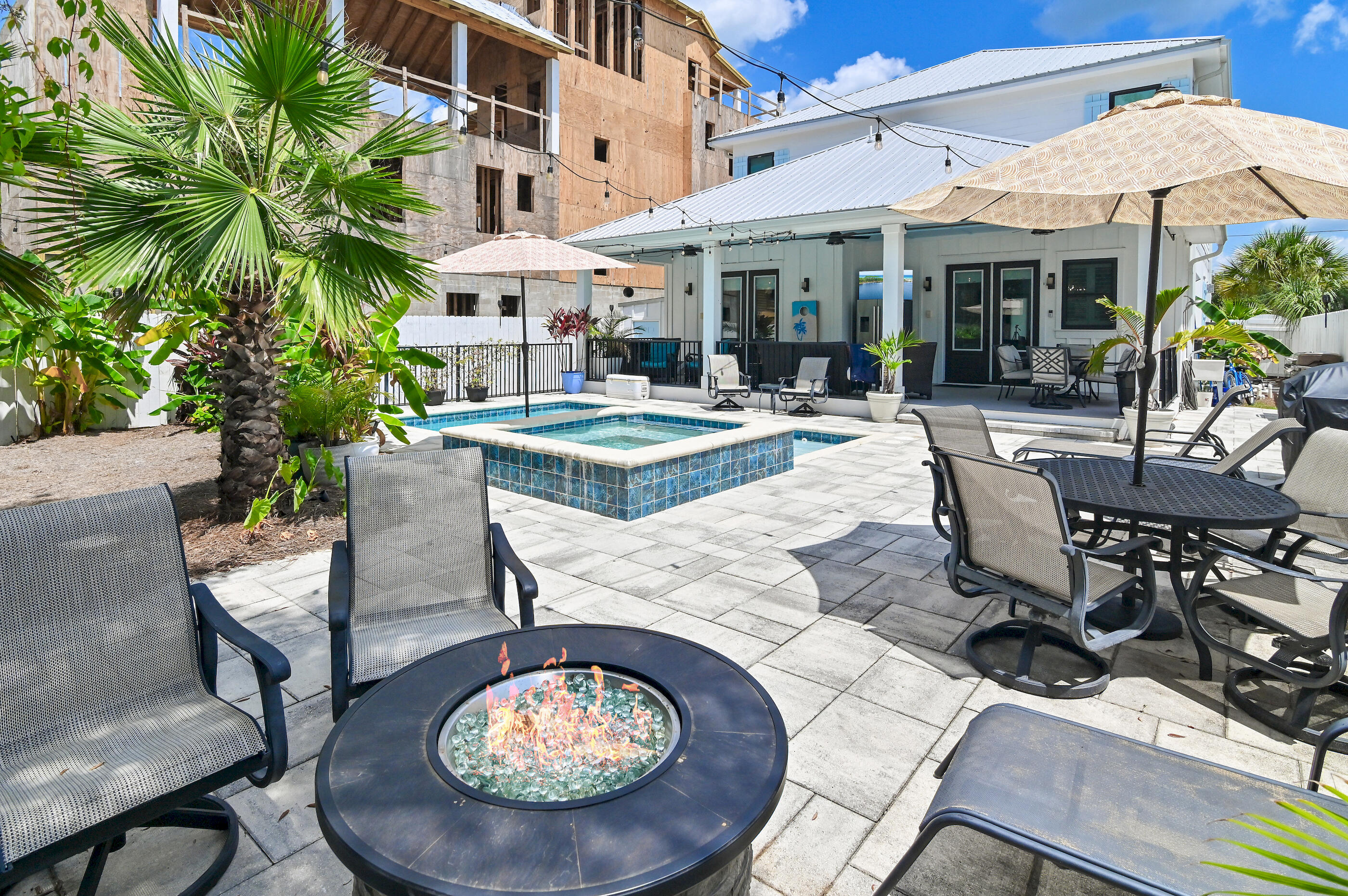 75 Pelayo Avenue Santa Rosa Beach, FL 32459 - Photo 10 of 67 a view of a patio with table and chairs potted plants and a large tree