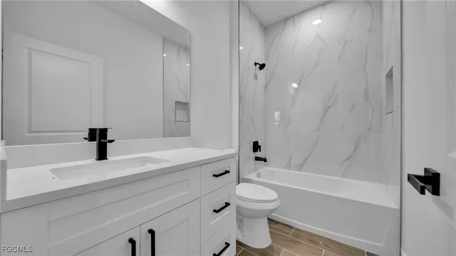 a bathroom with a sink a toilet and a bathtub