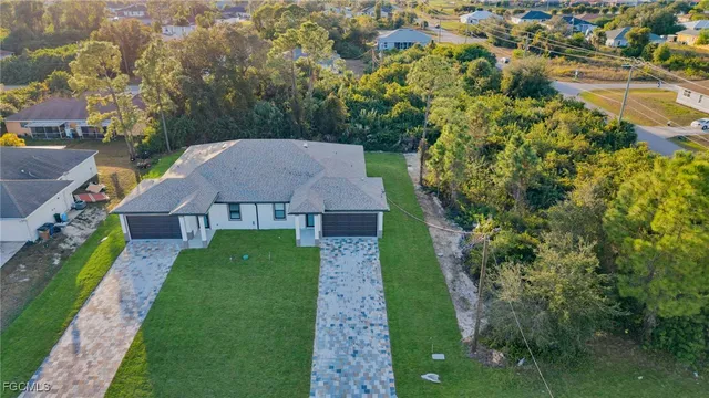 a aerial view of a house with yard and green space