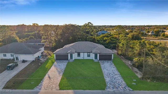 a view of a garden with a building in the background