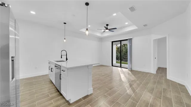 a view of a kitchen with sink and natural light