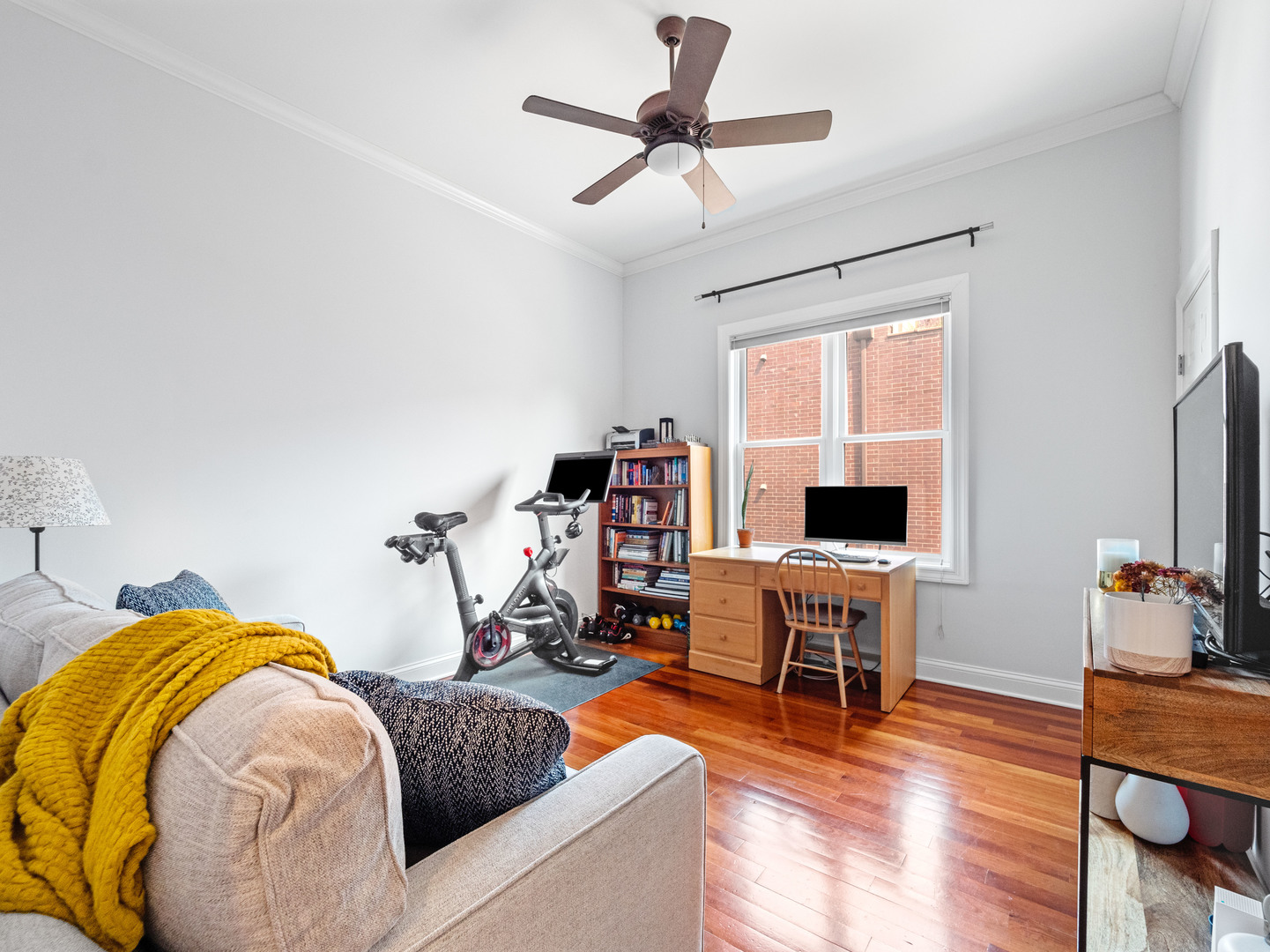 2940 North Sheffield Avenue, Unit 4N Chicago, IL 60657 - Photo 21 of 32 a living room with a couch and a flat screen tv with wooden floor
