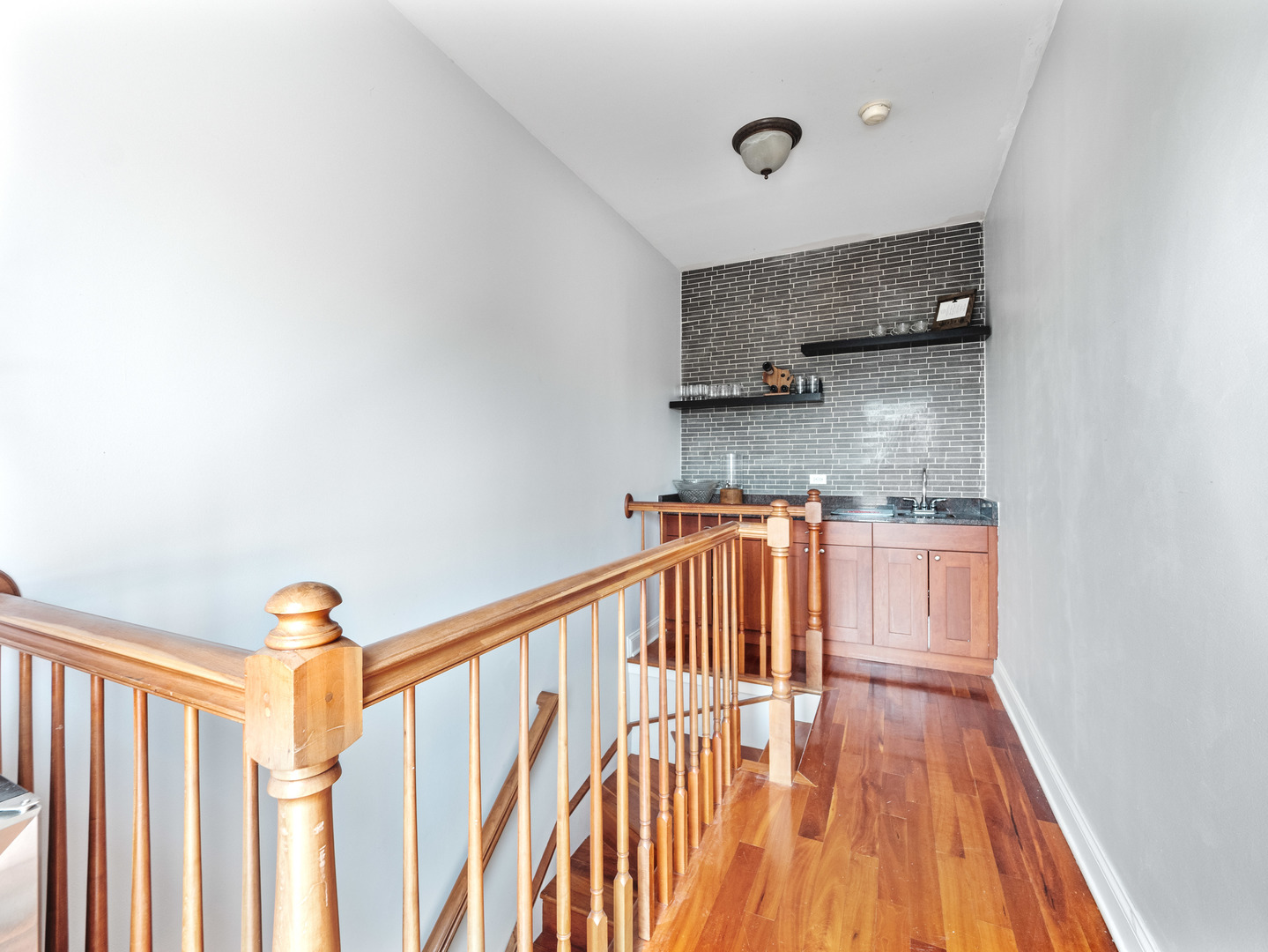 2940 North Sheffield Avenue, Unit 4N Chicago, IL 60657 - Photo 23 of 32 a hallway with a white stove top oven and sink