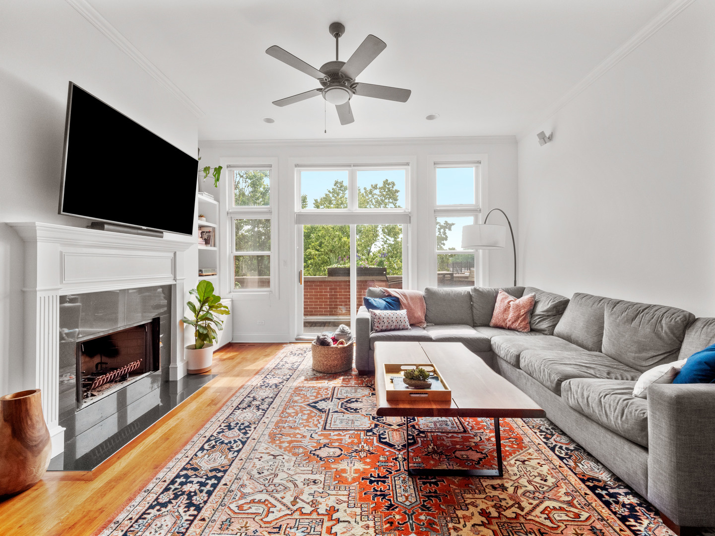 2940 North Sheffield Avenue, Unit 4N Chicago, IL 60657 - Photo 3 of 32 a living room with furniture a fireplace a flat screen tv and a large window