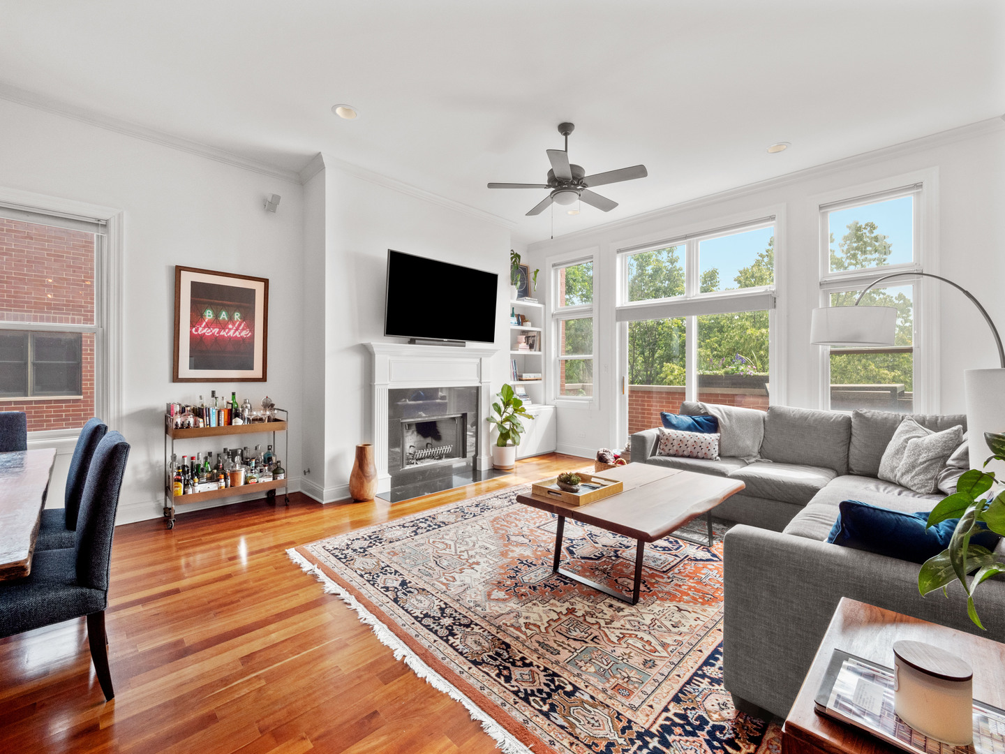 2940 North Sheffield Avenue, Unit 4N Chicago, IL 60657 - Photo 4 of 32 a living room with furniture a fireplace and a flat screen tv