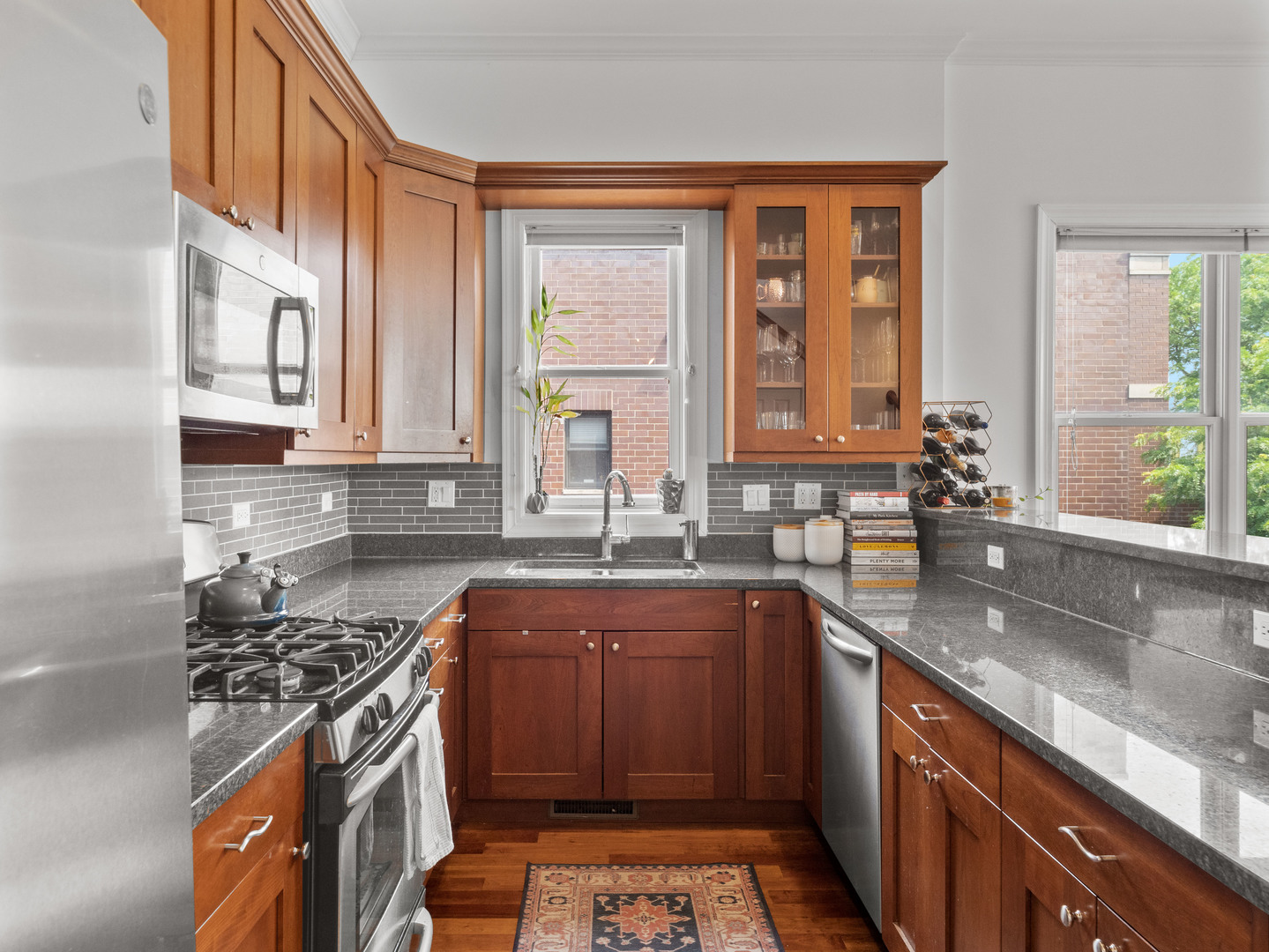 2940 North Sheffield Avenue, Unit 4N Chicago, IL 60657 - Photo 9 of 32 a kitchen with stainless steel appliances granite countertop a sink stove and cabinets