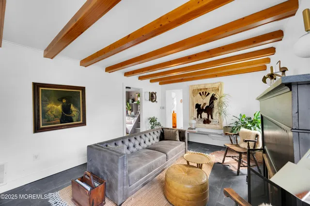 a living room with furniture and a painting