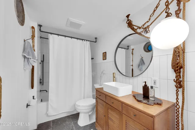 a bathroom with a toilet a sink and a mirror