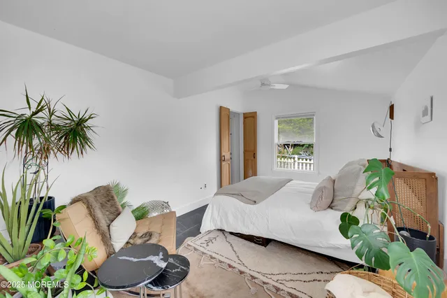 a bedroom with a bed and a couch