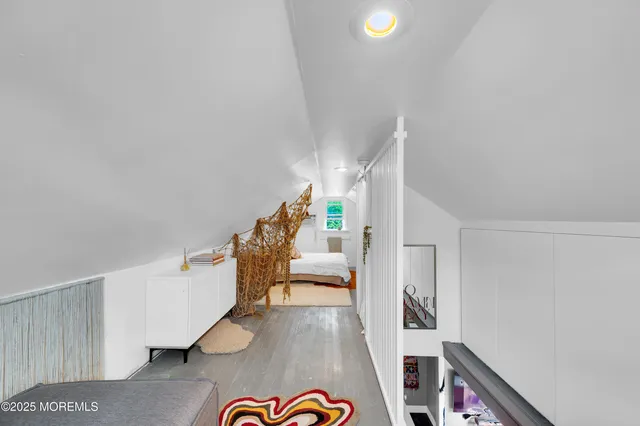 a view of entryway bedroom and hall with wooden floor