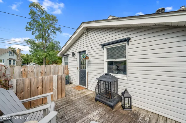 a front view of a house with wooden deck