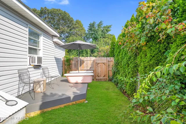 a view of a chair and table in backyard of the house