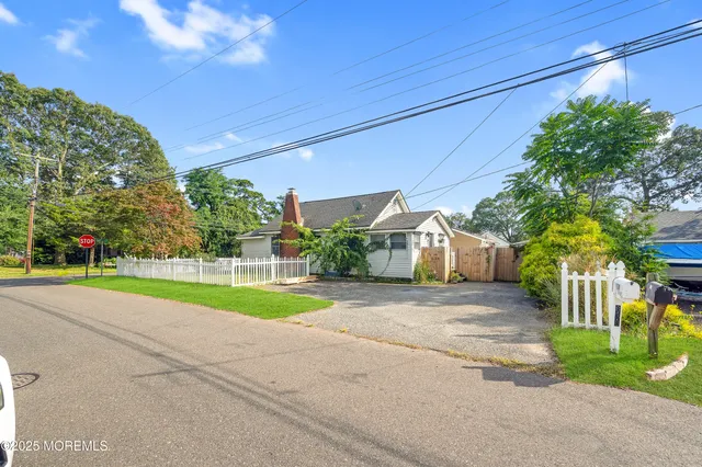 a view of a house with a yard and a street
