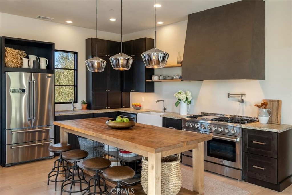 3940 Gruenhagen Flat Road Paso Robles, CA 93446 - Photo 14 of 63 a kitchen with a table chairs stove and refrigerator