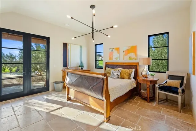 a bedroom with a bed and a mirror