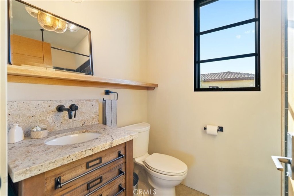 3940 Gruenhagen Flat Road Paso Robles, CA 93446 - Photo 38 of 63 a bathroom with a granite countertop sink and a mirror