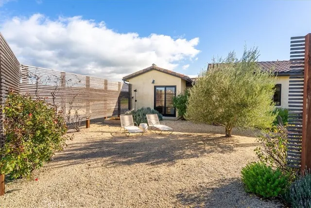 a bed room with furniture and large windows