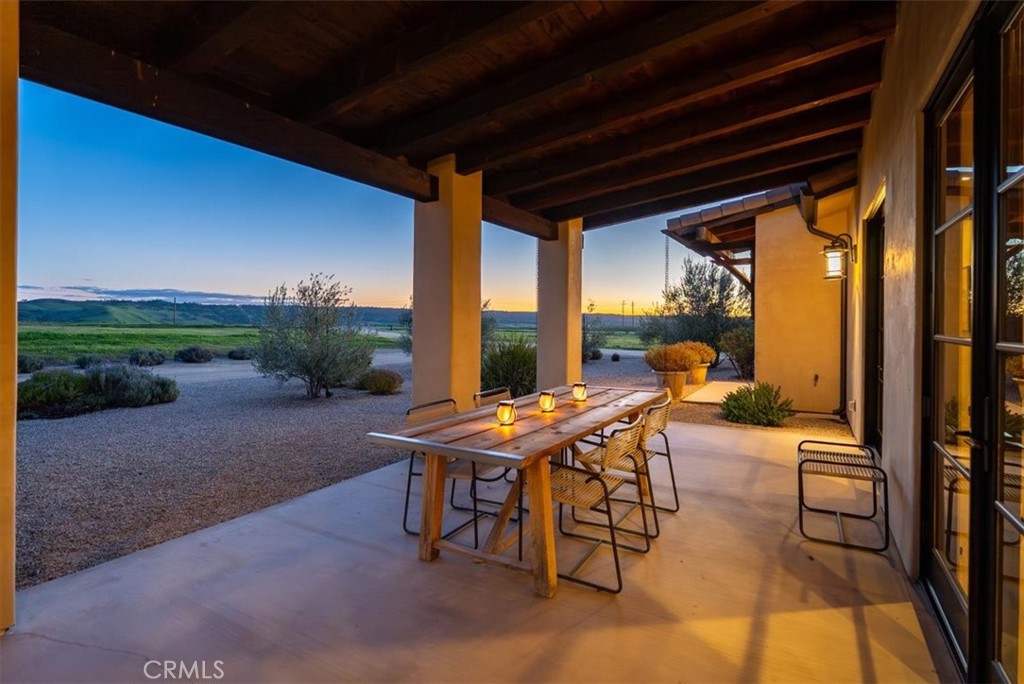 3940 Gruenhagen Flat Road Paso Robles, CA 93446 - Photo 47 of 63 a view of a patio with table and chairs and floor to ceiling window