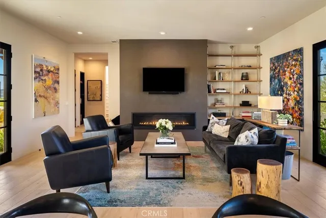 a living room with furniture and kitchen view